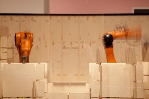 Robot arms at work moving boxes; the precision of their mechanical dance was mesmerising